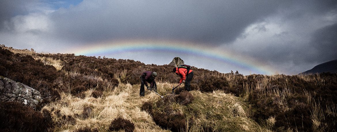 Working under moody skies and a rainbow on the Tea-Hut Path in Torridon at the Take Care of Your Trails in Torridon.